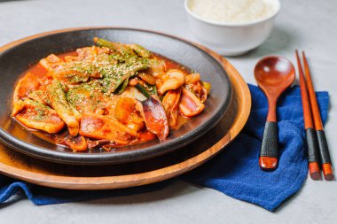 Korean food Stir-fried Squid, ojingeobokkeum : Squid stir-fried with onions, carrots, and cabbage in a spicy mixture of gochujang and red chili powder.
