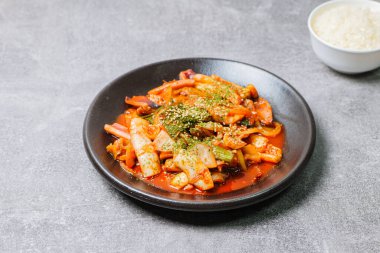Korean food Stir-fried Squid, ojingeobokkeum : Squid stir-fried with onions, carrots, and cabbage in a spicy mixture of gochujang and red chili powder.