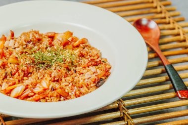 Korean food Kimchi Fried Rice Kimchibokkeumbap, Rice fried with finely chopped kimchi. Beef, pork, onions, green onions, and other vegetables may be added according to taste.