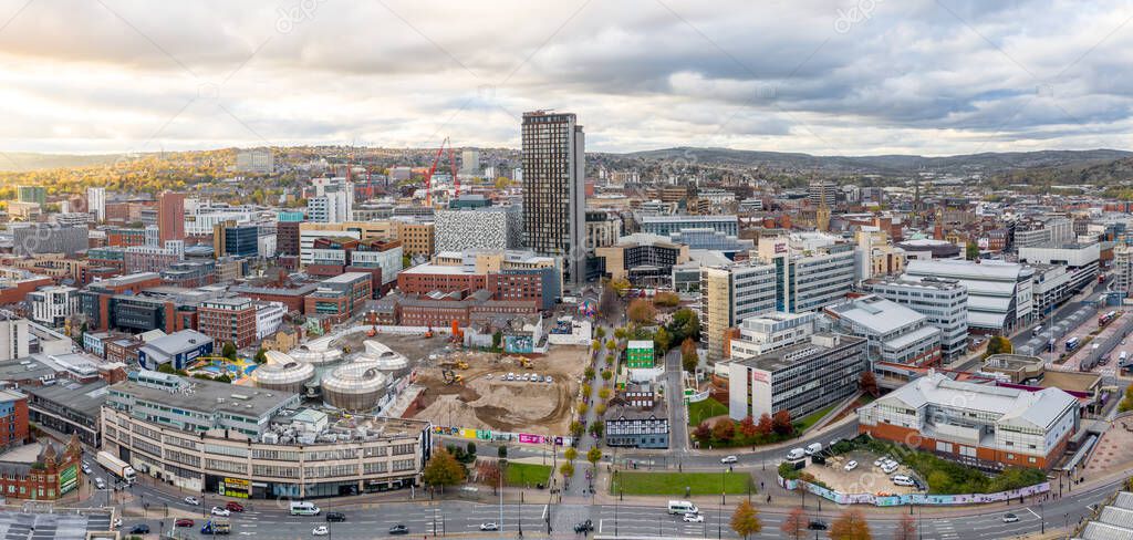 An aerial panorama view of Sheffield city centre and cityscape skyline at sunset