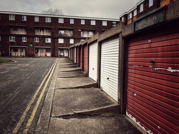 A typical social housing or council house estate in the North of England with rows of garages and flats during the UK Governments levelling up promise
