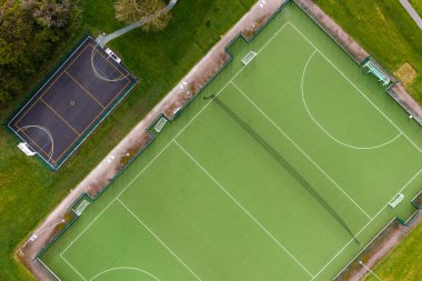 An aerial view of a sports stadium with outdoor hockey pitch and basketball court for amateurs