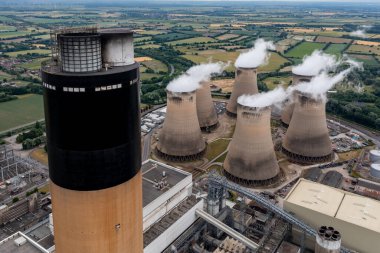 Aerial view at the top of a tall chimney in a coal fired power station in an air pollution and carbon dioxide emissions concept with copy space clipart