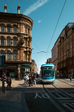 BIRMINGHAM, UK - JULY 18, 2022.  A West Midlands Metro Tram service travelling along tracks on the city streets of Birmingham city centre