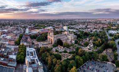 PETERBOROUGH, UK - AUGUST 4, 2022.  An aerial cityscape of Peterborough Cathedral and town centre at sunset