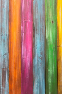 Vertical full frame background of vibrant and multi colored wooden planks with copy space