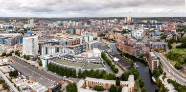 LEEDS, UK - AUGUST 19, 2022.  An aerial panorama cityscape of Leeds Dock area of the city centre with luxury waterfront properties at Roberts Wharf