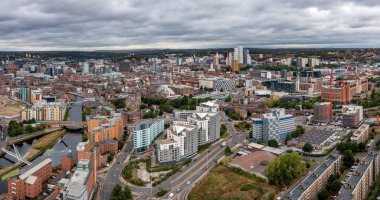 LEEDS, UK - AUGUST 24, 2022.  Aerial view of Leeds city cityscape in West Yorkshire with old and new architecture with riverside living in luxury apartment blocks