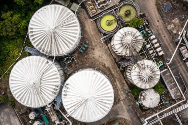 Aerial view directly above storage tanks and silos at a oil or gas terminal plant with interconnecting pipework