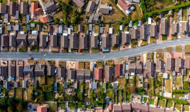 Aerial view directly above a suburban housing estate with a road providing access for homeowners