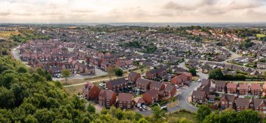 KIPPAX, LEEDS, UK - SEPTEMBER 2, 2022.  Aerial view of a new build housing development on the outskirts of a village in a housing expansion concept