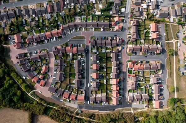 Aerial view directly above a new build housing development on the outskirts of a village in a housing expansion concept