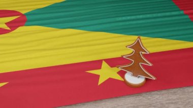 Masasında Grenada bayrağı olan zencefilli kurabiye evi.