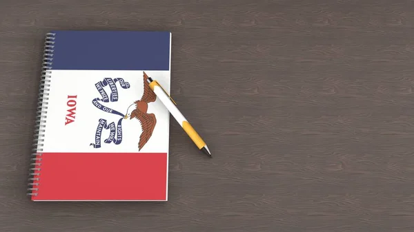Iowa bayrağı ve yalancı bir kalemi olan bir defter.
