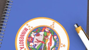 Minnesota bayrağı ve yalancı bir kalemin olduğu bir defter.