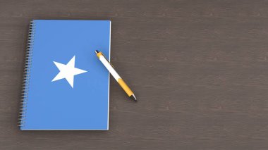 Somali bayrağı ve yalancı bir kalemin olduğu bir defter.