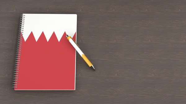 Bahreyn bayrağı ve yalancı bir kalemin olduğu bir defter.
