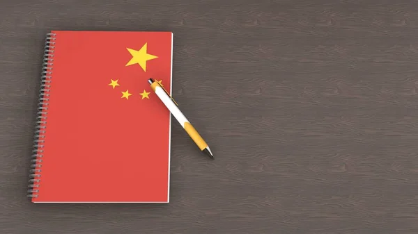 Üzerinde Çin Bayrağı Yalancı Bir Kalem Olan Bir Defter — Stok fotoğraf