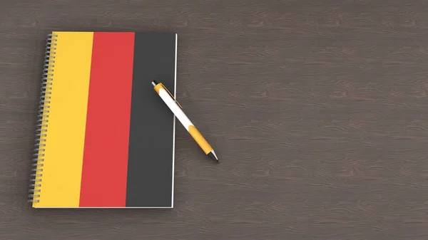 Almanya bayrağı ve yalancı bir kalemin olduğu bir defter.