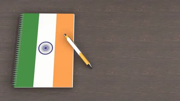 Üzerinde Hindistan bayrağı ve bir kalem olan bir defter.