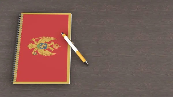 Karadağ bayrağı ve yalancı bir kalemle dolu bir defter.