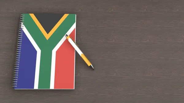 Güney Afrika bayrağı ve yalancı bir kalemin olduğu bir defter.