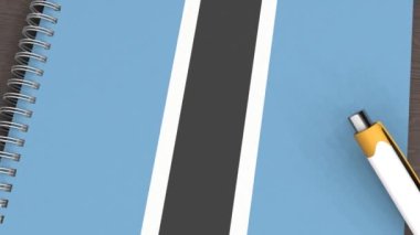 Botswana bayrağı ve yalancı bir kalemin olduğu bir defter.