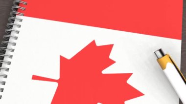 Kanada bayrağı ve yalancı bir kalemin olduğu bir defter.