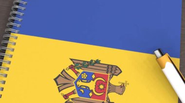 Moldova bayrağı ve yalancı bir kalemin olduğu bir defter.