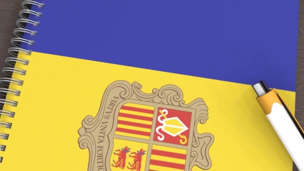 Een Notitieboekje Met Vlag Van Andorra Een Liggende Pen — Stockvideo