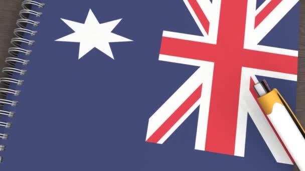 Ein Notizbuch Mit Der Flagge Australiens Und Einem Lügenstift — Stockvideo