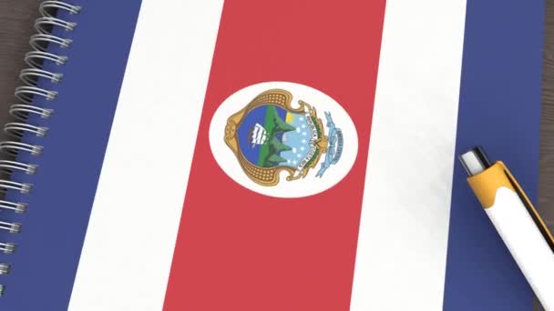Kosta Rika Bayrağı Yalancı Bir Kalemle Dolu Bir Defter — Stok video
