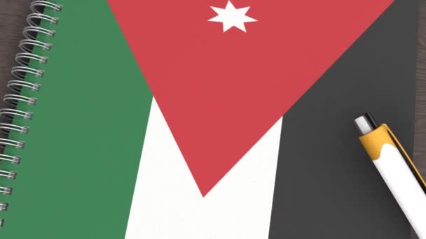 Ένα Σημειωματάριο Σημαία Της Ιορδανίας Και Ένα Στυλό Που Βρίσκεται — Αρχείο Βίντεο