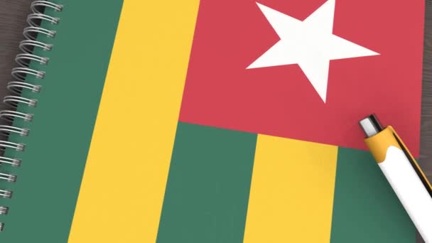Cuaderno Con Bandera Togo Bolígrafo Mentiroso — Vídeos de Stock