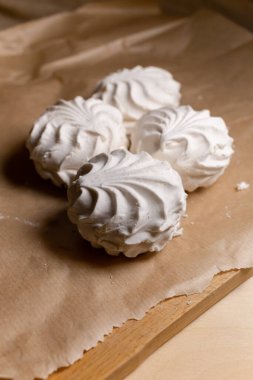 Vanilla white marshmallows are on the cutting board. Vertical image. Sweets for tea.