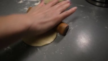 Making dough by female hands on grey table background