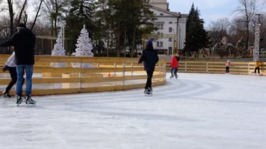 People skating during the day, having fun and studying on ice rink near Drama Theater Mariupol, Ukraine. Several days Before war Russian against Ukraine Start.