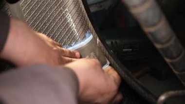 Repair service for wheel tire of car from big side puncture, cut with special plaster by professional mechanic.