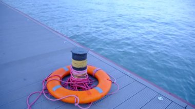 Ring life bouy on pier of marina, swimming pool with red rope in Azov Sea, Mariupol