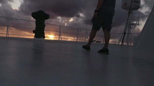 Hombre caminando en la cubierta superior de la cubierta de puente superior de la gran embarcación de carga en el tiempo de puesta del sol con balanceo. — Vídeos de Stock
