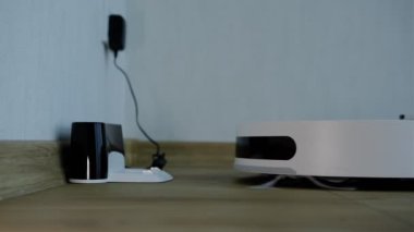 Robotic Vacuum Cleaner start from recharge station. Smart Cleaning Technology. Modern smart electronic housekeeping technology.