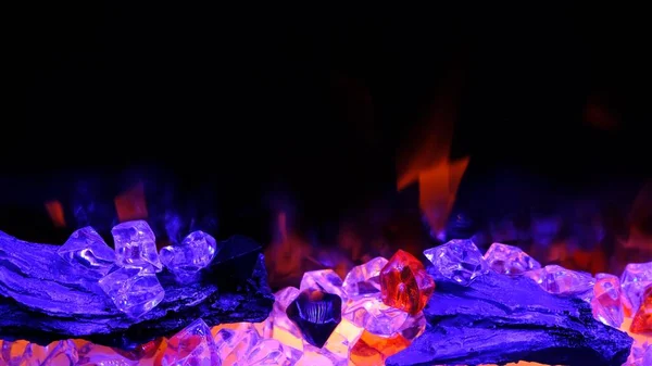 view on electric fireplace with artificial sparkling flame, decor for the interior, orange flame on purple crystals.