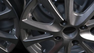 close up view on beautifu ray alloy, aluminum, metal disks for car on stand in a shop. Car wheel disk