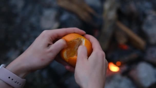 Slow Motion Woman Hand Peeling Ripe Sweet Tangerine Close Fireplace — Stock Video