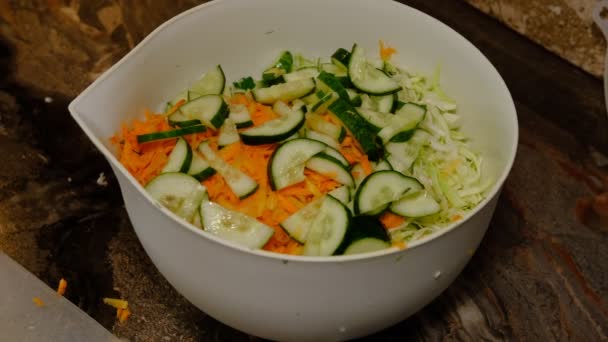 Old Woman Hands Cook Adding Fresh Cucumber Slices Bowl Salad — стоковое видео