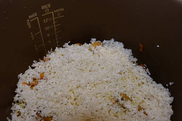 Cooking rice with meat and vegetables in pressure multi cooker step by step. Add rice, pilaff.