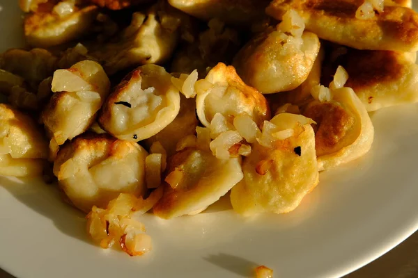 Homemade potato dumplings or vereniki pierogi, served with fried onions. Rustic style, comfort eastern europe cuisine.