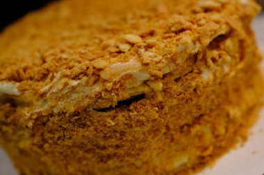 Board with delicious Napoleon cake, close up with selective blur.