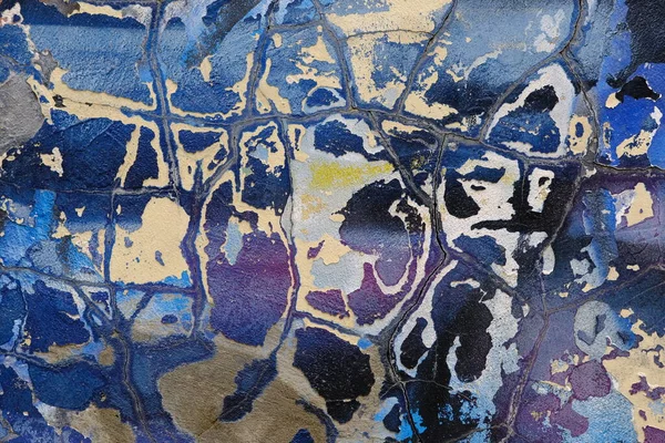 Colorful wall background with damaged paints of blue.