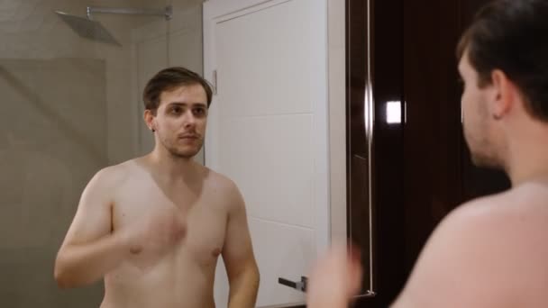 Young Man Examining His Face While Watching Mirror — Stockvideo